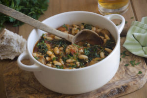 Sausage, cannellini beans and kale stew in a pot